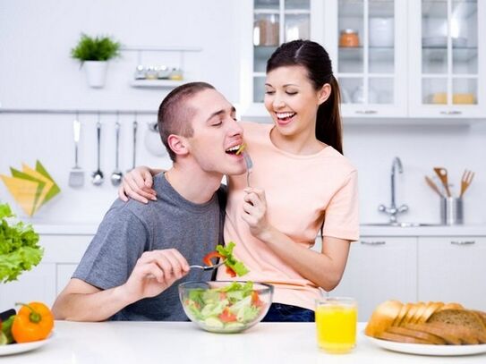 The girl feeds her husband with products to increase strength