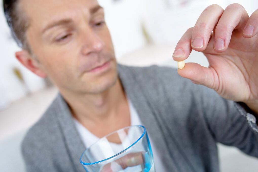 a man drinks a pill to increase strength